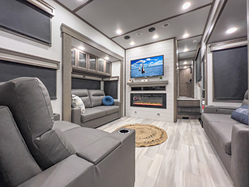 The living area and TV inside a Grand Design Solitude 5th wheel