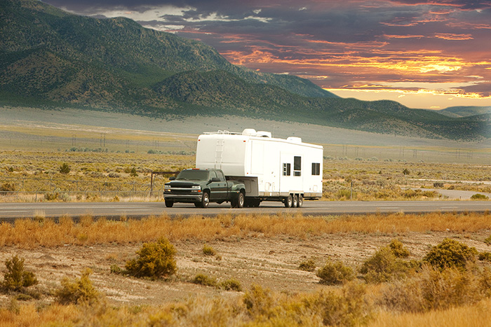 Truck pulling 5th wheel in desert