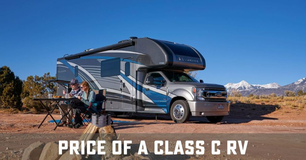 Class C RV in mountains with couple outside enjoying mountain view