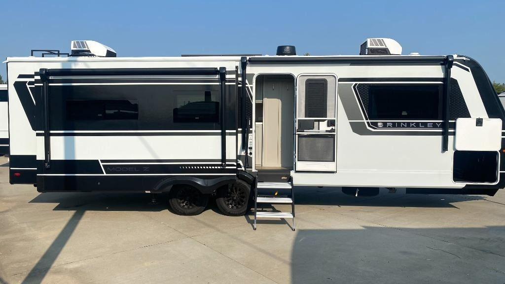 Brinkley Travel Trailer side view with slide extended and entry door open