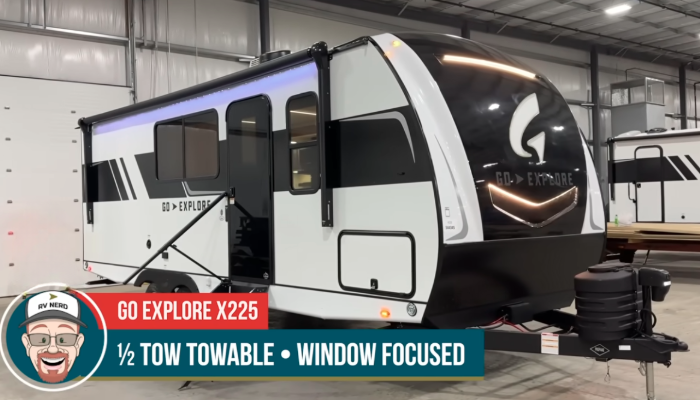 Exterior of the GO Explore X225 travel trailer, designed as a 1/2-ton towable model with a focus on large windows for natural light. The sleek black and white exterior features aerodynamic styling, LED lighting, and dual propane tanks, offering a modern and functional option for adventurers.
