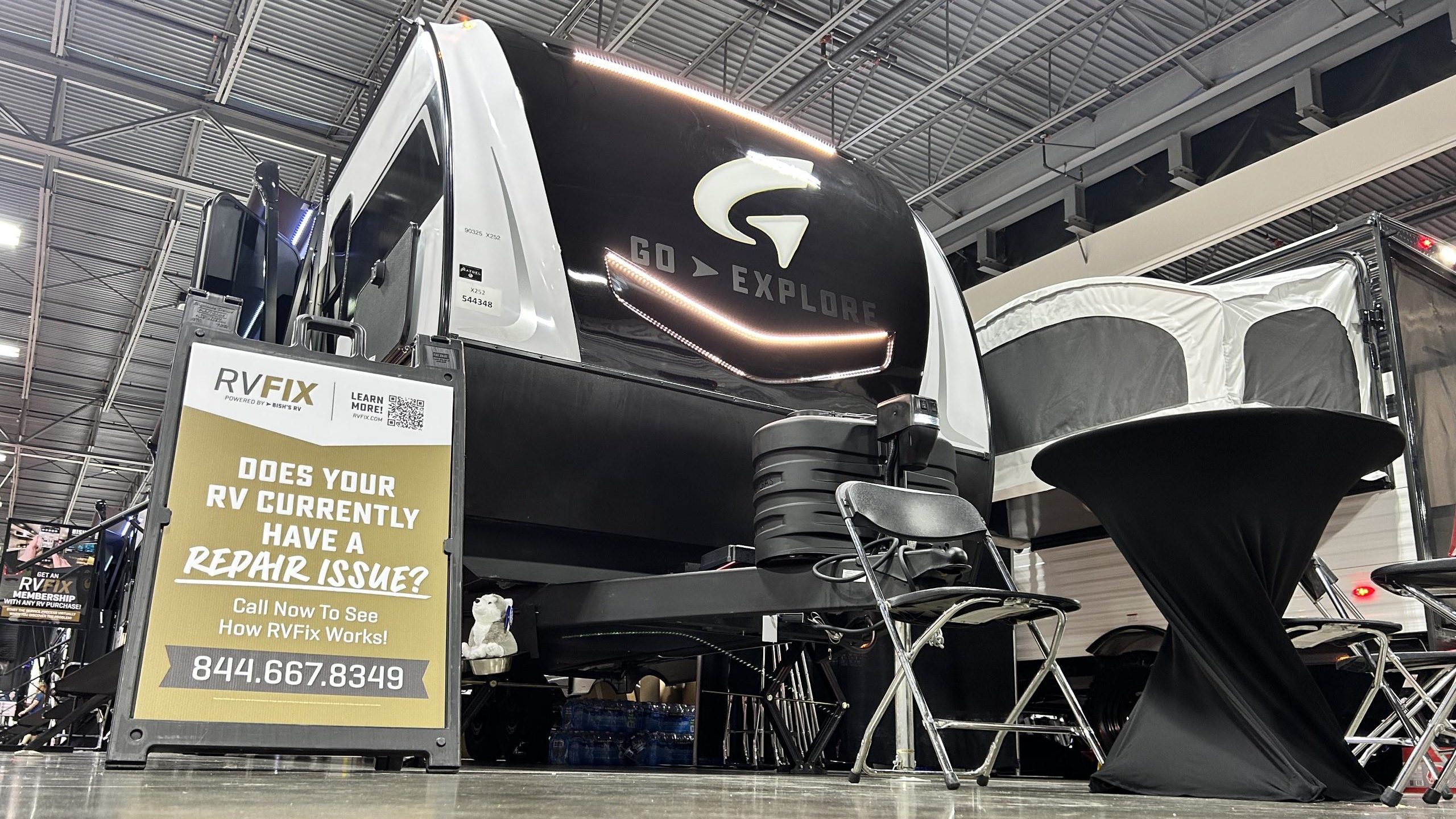 RV at show with a sign for repair service