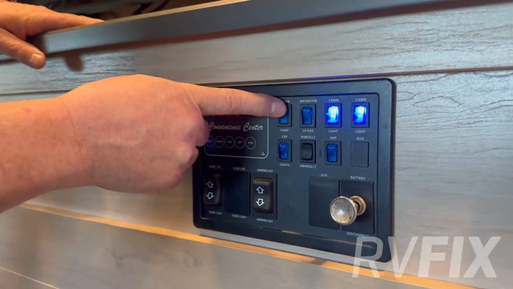 RV tech turning on water heater using control panel