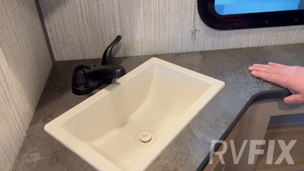 RV tech clearing air out of water lines