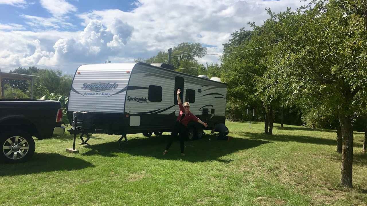 happy woman outside her springdale camper