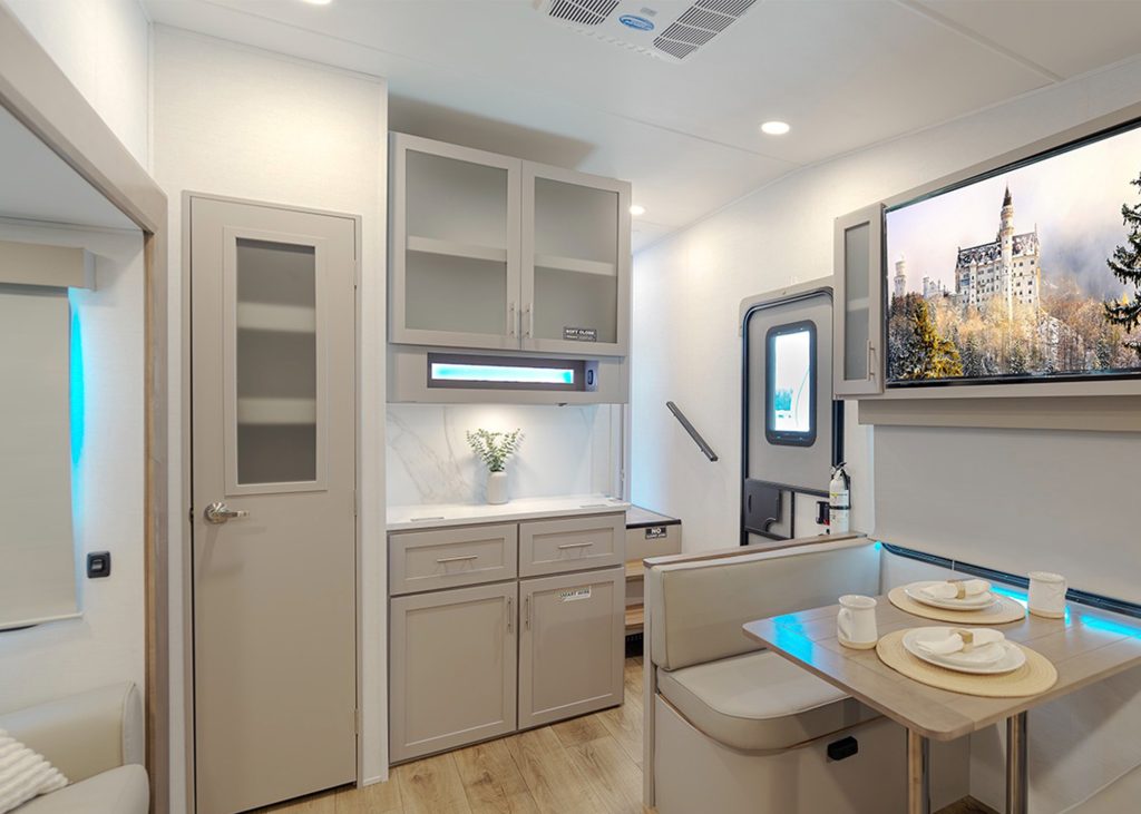 living area of Avenue 23ML showing TV and dinette