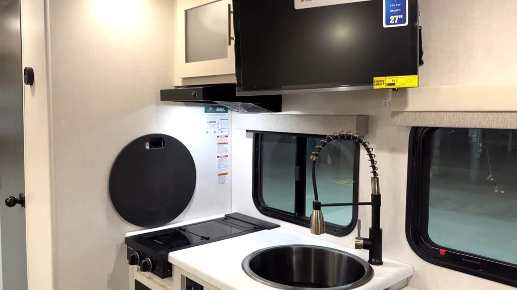 Kitchen and hanging/swinging TV inside R-Pod 153