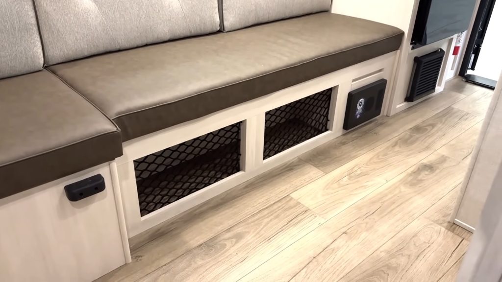 Storage area beneath sofa inside R-Pod 153