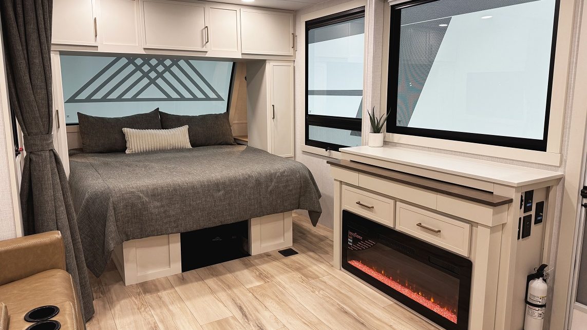 Bed and fireplace inside Brinkley Model I 235
