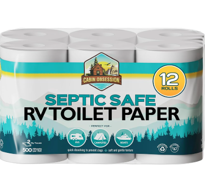 A 12-roll pack of Cabin Obsession brand septic-safe RV toilet paper. The packaging features a mountain and forest design with icons indicating it's ideal for RVs, campsites, and boats. The label highlights that the toilet paper is 2-ply, 500 sheets per roll, quick-dissolving to prevent clogs, and designed for soft, gentle use in septic systems.