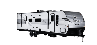 A white and black Jayco travel trailer with dual axles and a modern aerodynamic front cap. The trailer features multiple windows, two rooftop air conditioning units, exterior storage compartments, and a fold-down entry staircase. Designed for towing, it offers a sleek and contemporary RV design.