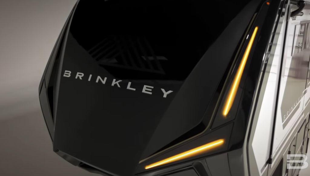 Brinkley RV front cap with amber LED accent lighting and bold logo, highlighting luxury styling and modern RV design.