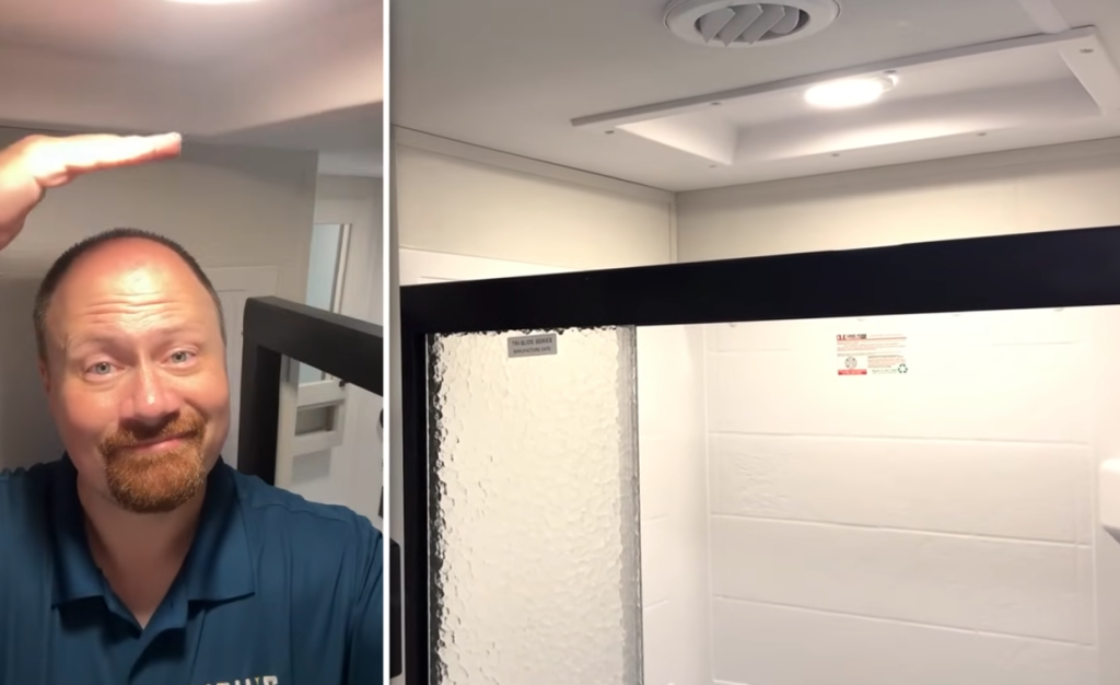 2026 Grand Design Reflection 150 270BN shower with skylight providing extra headroom, white tile-style surround, and glass door enclosure for a bright, spacious bathroom design.