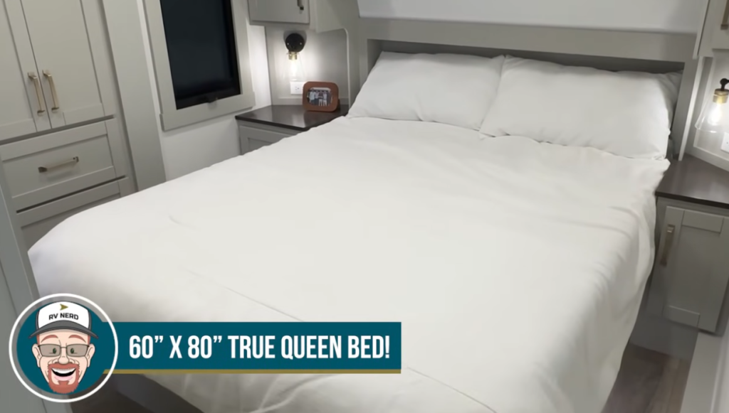 Brinkley Model Z bedroom featuring a 60” x 80” true queen bed with overhead storage, nightstands on both sides, and soft lighting for a residential, hotel-style comfort feel.