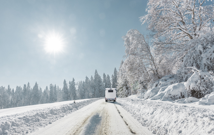 Campers on a snowy road in the mountains