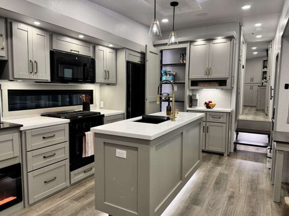 Brinkley Model Z 3600 kitchen featuring a center island with gold faucet, modern lighting, residential appliances, spacious cabinetry, and a sleek coffee bar with open shelving.