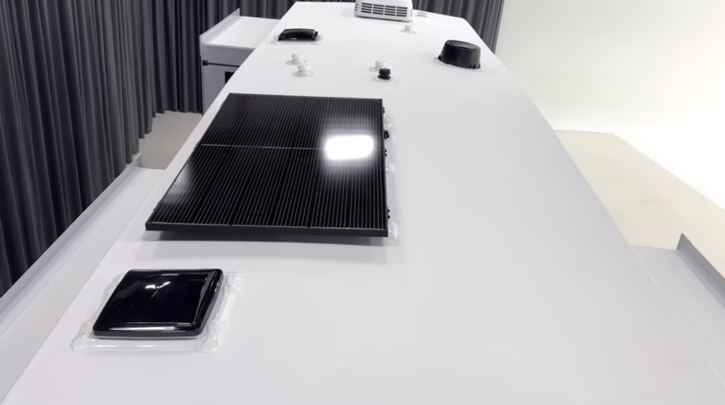 Roof of the Brinkley Model Z fifth wheel RV featuring a mounted solar panel, roof vents, and air conditioning unit, showcasing clean installation and energy-efficient design.