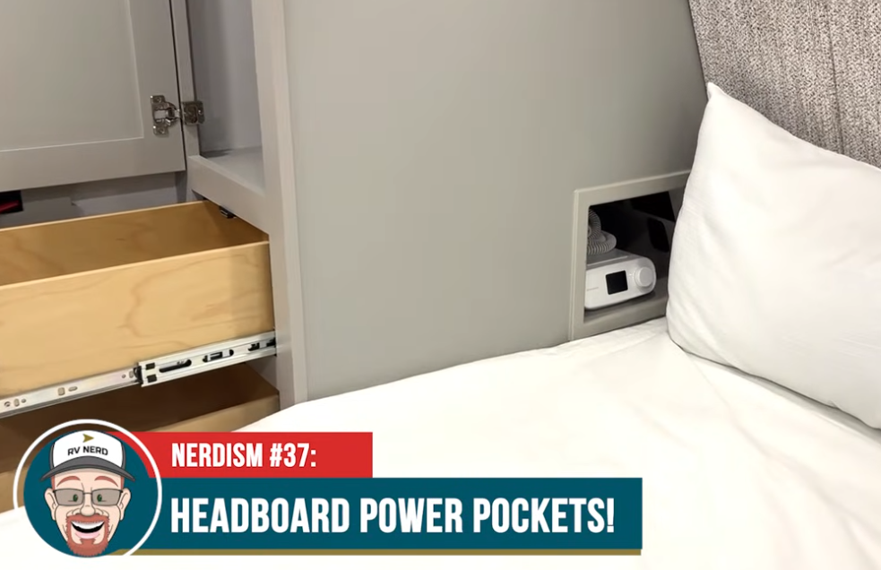 Headboard power pocket in the 2026 Brinkley Model Z Air, showing built-in CPAP storage with outlets beside the queen bed and adjacent soft-close bedside drawers.