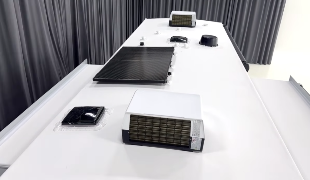 Roof of the 2026 Brinkley Model Z Air 315 showcasing the 370W solar panel, triple air conditioners, roof vents, heavy MS polymer sealants, and fully walkable construction.