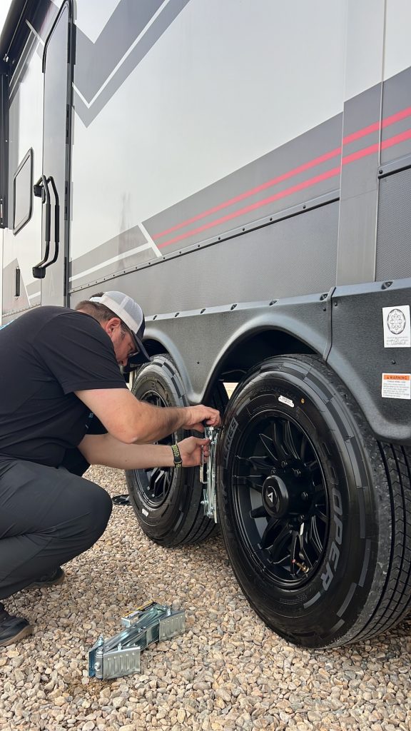person installing x chocks and wheel chocks