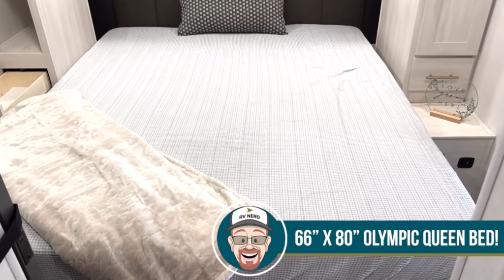 RV bedroom with 66x80 Olympic queen bed in travel trailer main sleeping area