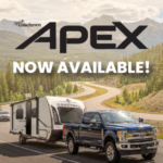 a truck pulling an Apex Travel Trailer